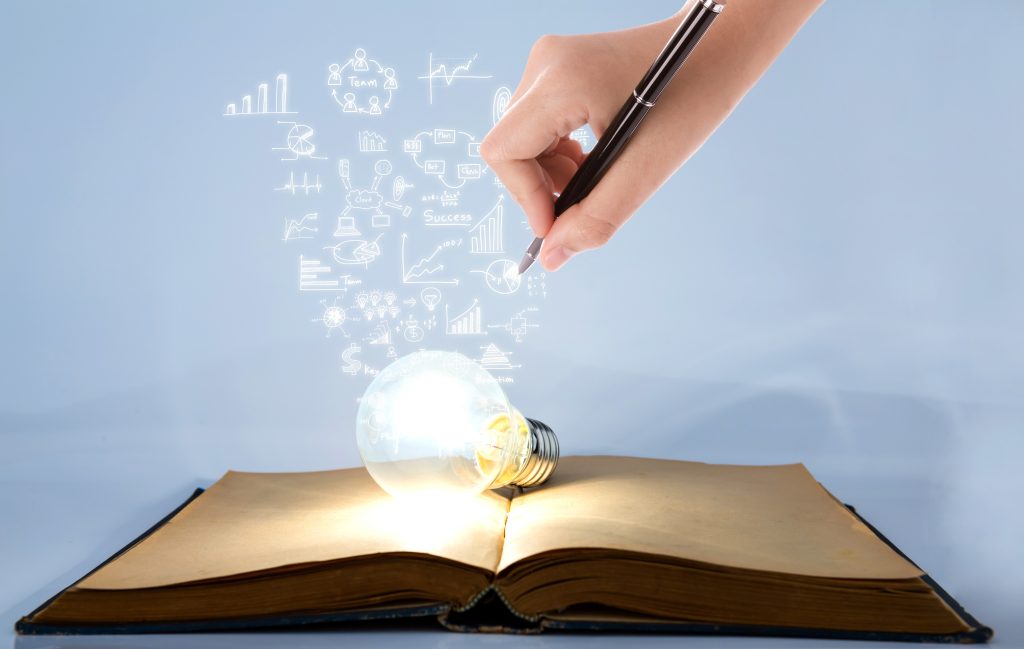 book and light bulb with hand drawing graph